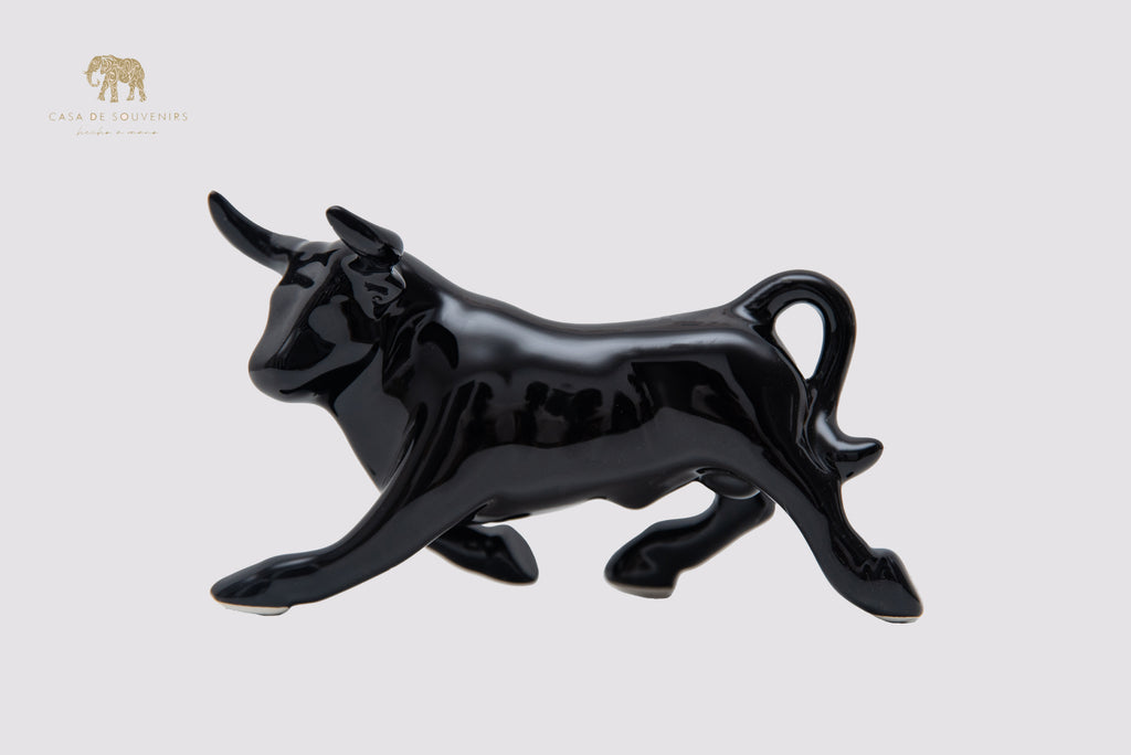 This is a sleek and elegant black bull figurine made of high-quality porcelain From Spain