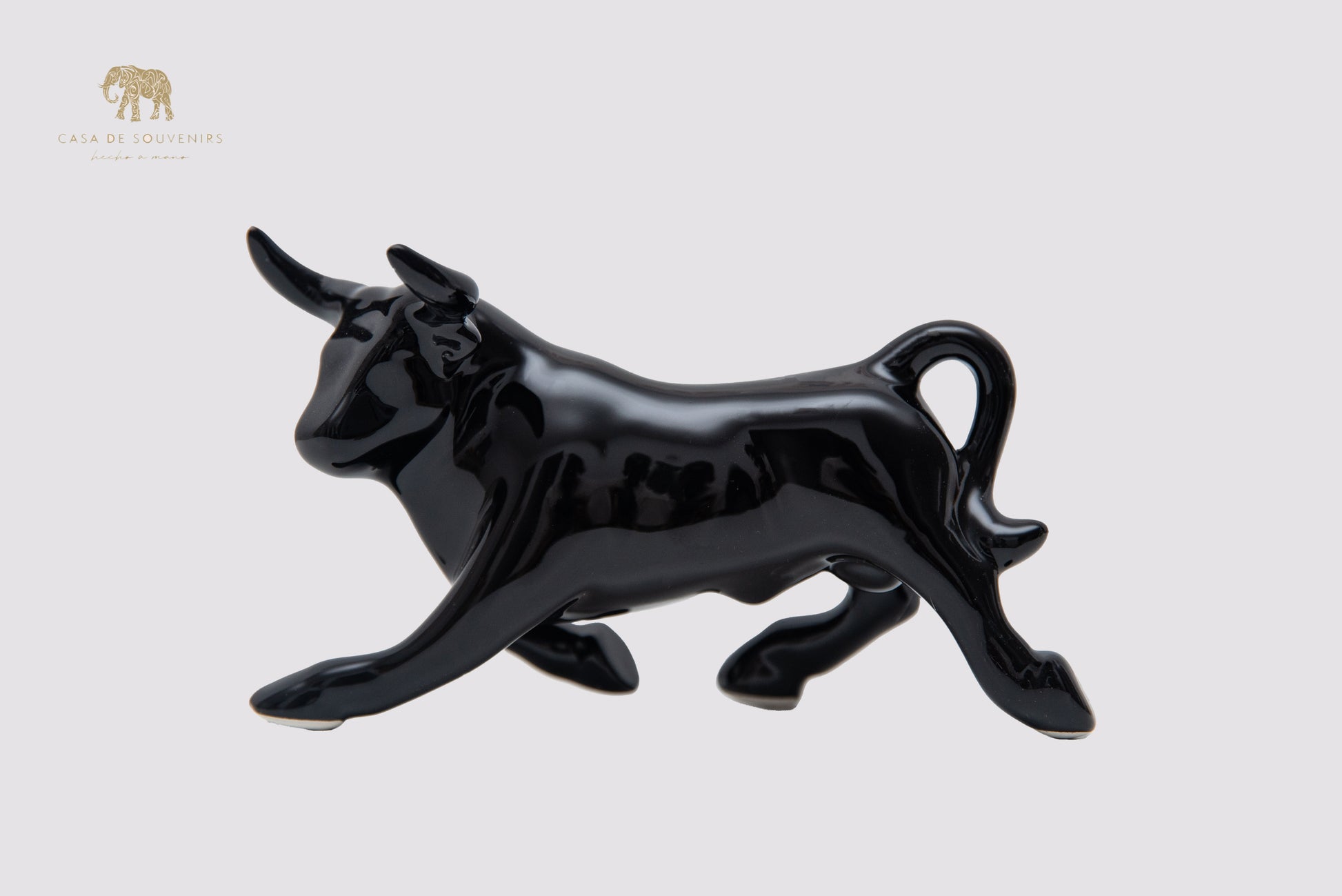 This is a sleek and elegant black bull figurine made of high-quality porcelain From Spain