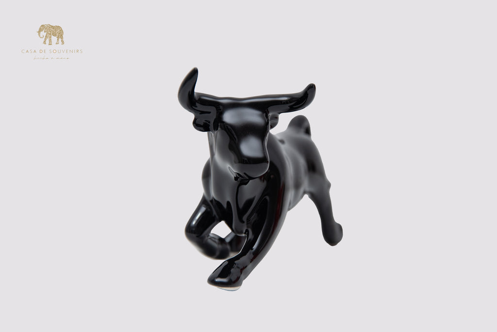 This is a sleek and elegant black bull figurine made of high-quality porcelain From Spain