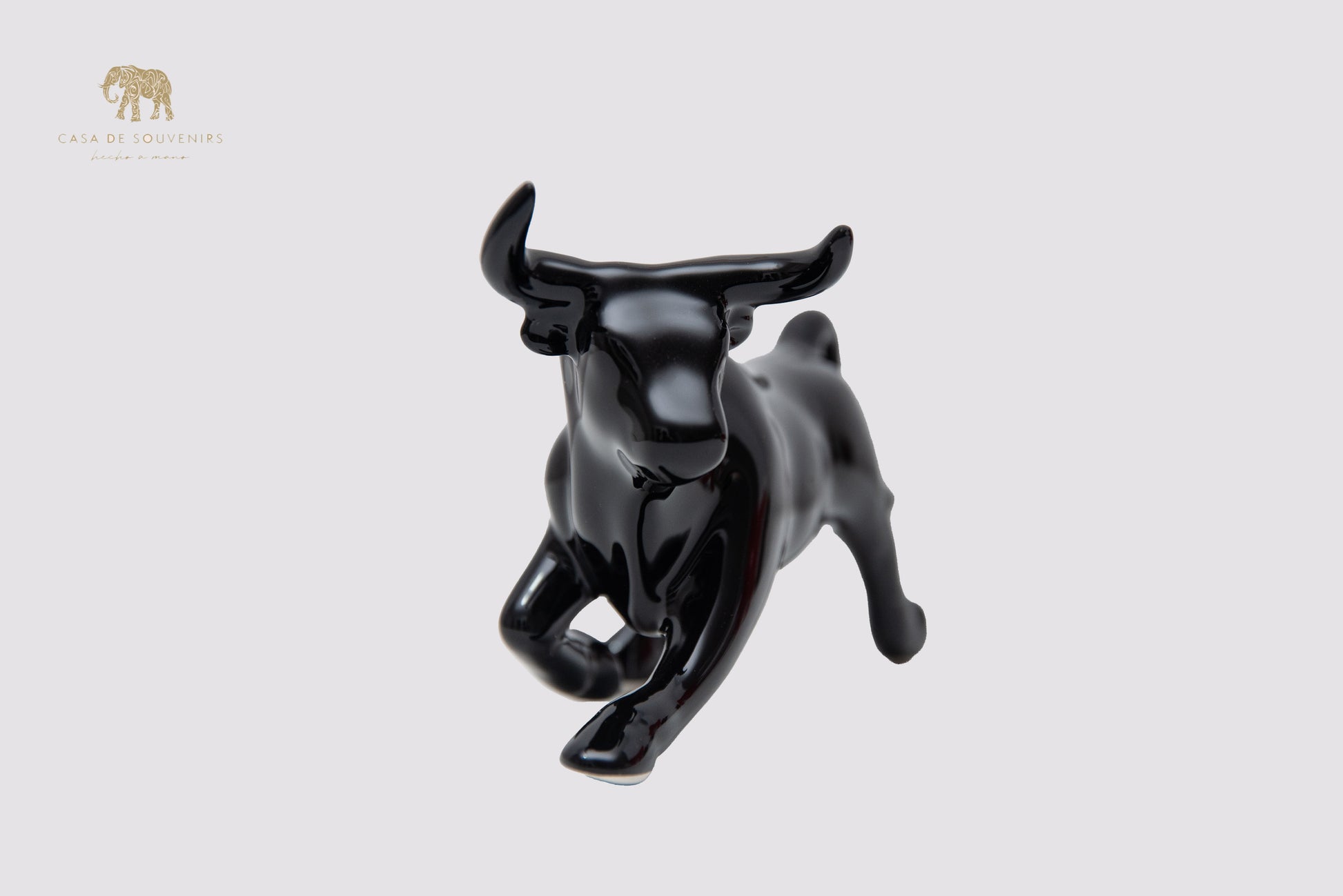 This is a sleek and elegant black bull figurine made of high-quality porcelain From Spain