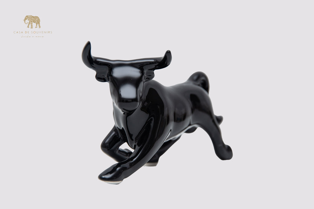 This is a sleek and elegant black bull figurine made of high-quality porcelain From Spain