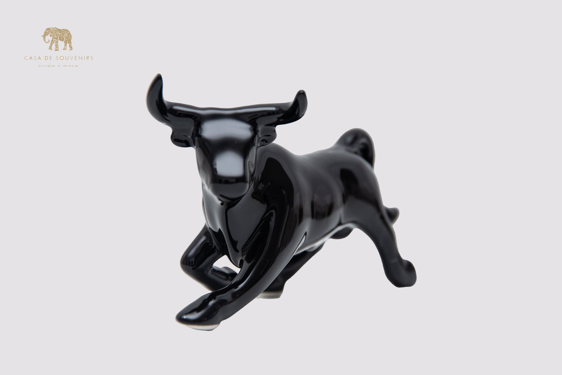 This is a sleek and elegant black bull figurine made of high-quality porcelain From Spain
