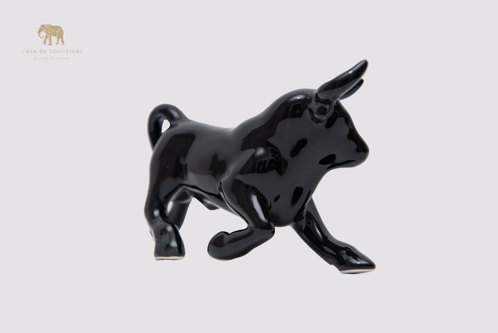 This is a sleek and elegant black bull figurine made of high-quality porcelain From Spain