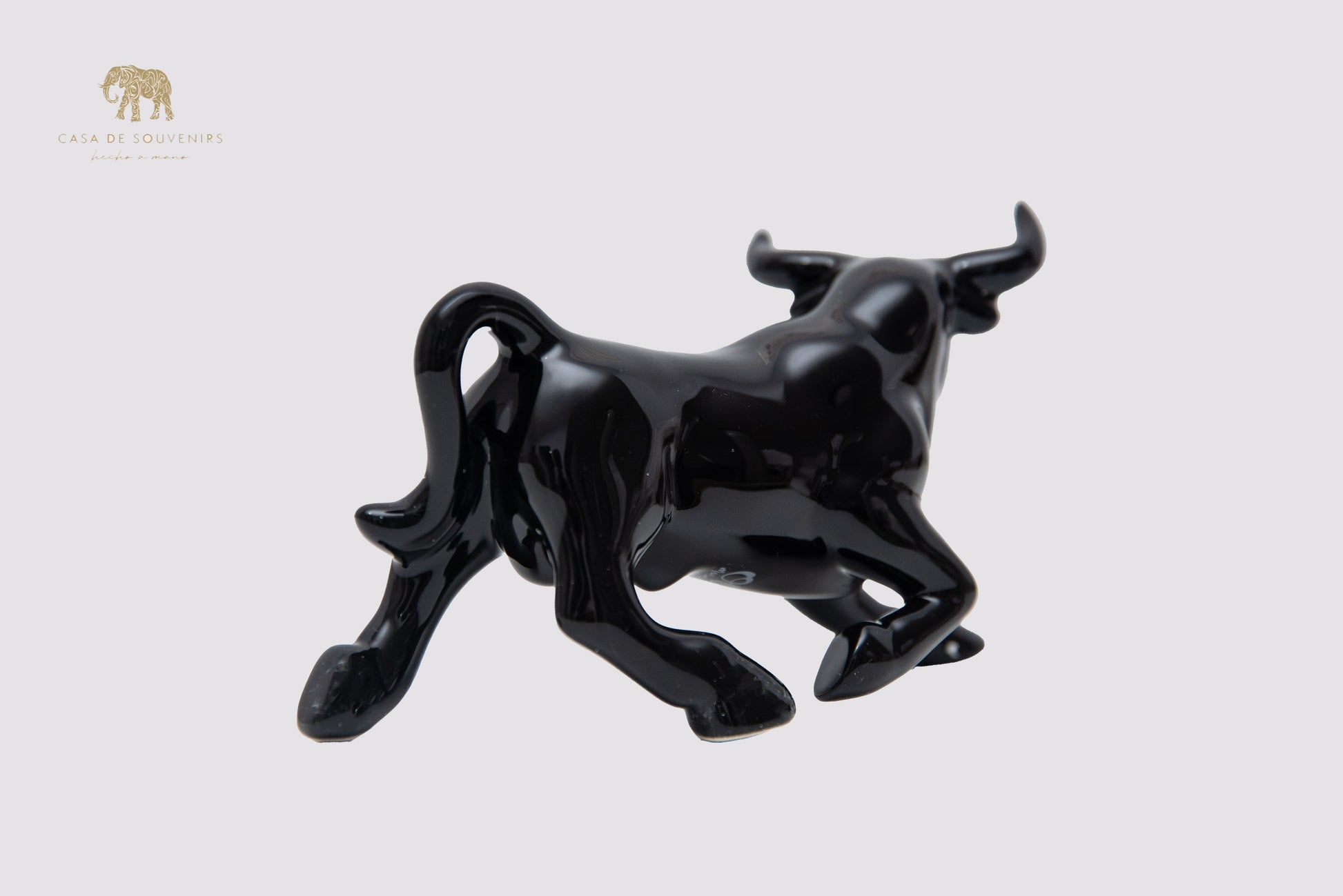 This is a sleek and elegant black bull figurine made of high-quality porcelain From Spain