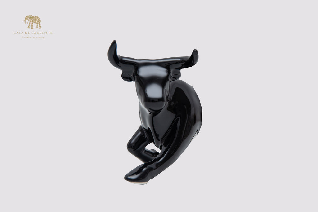 This is a sleek and elegant black bull figurine made of high-quality porcelain From Spain