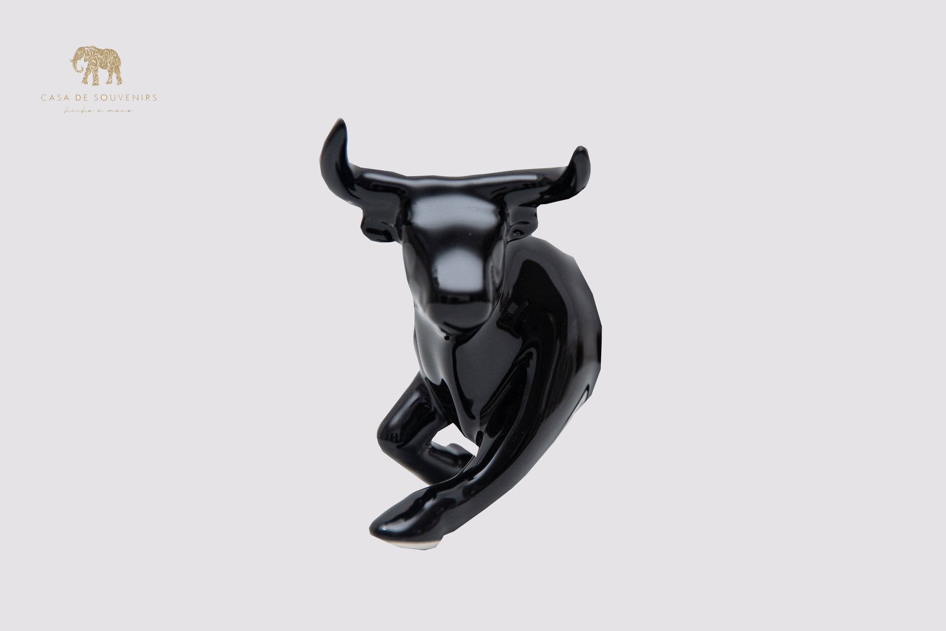 This is a sleek and elegant black bull figurine made of high-quality porcelain From Spain