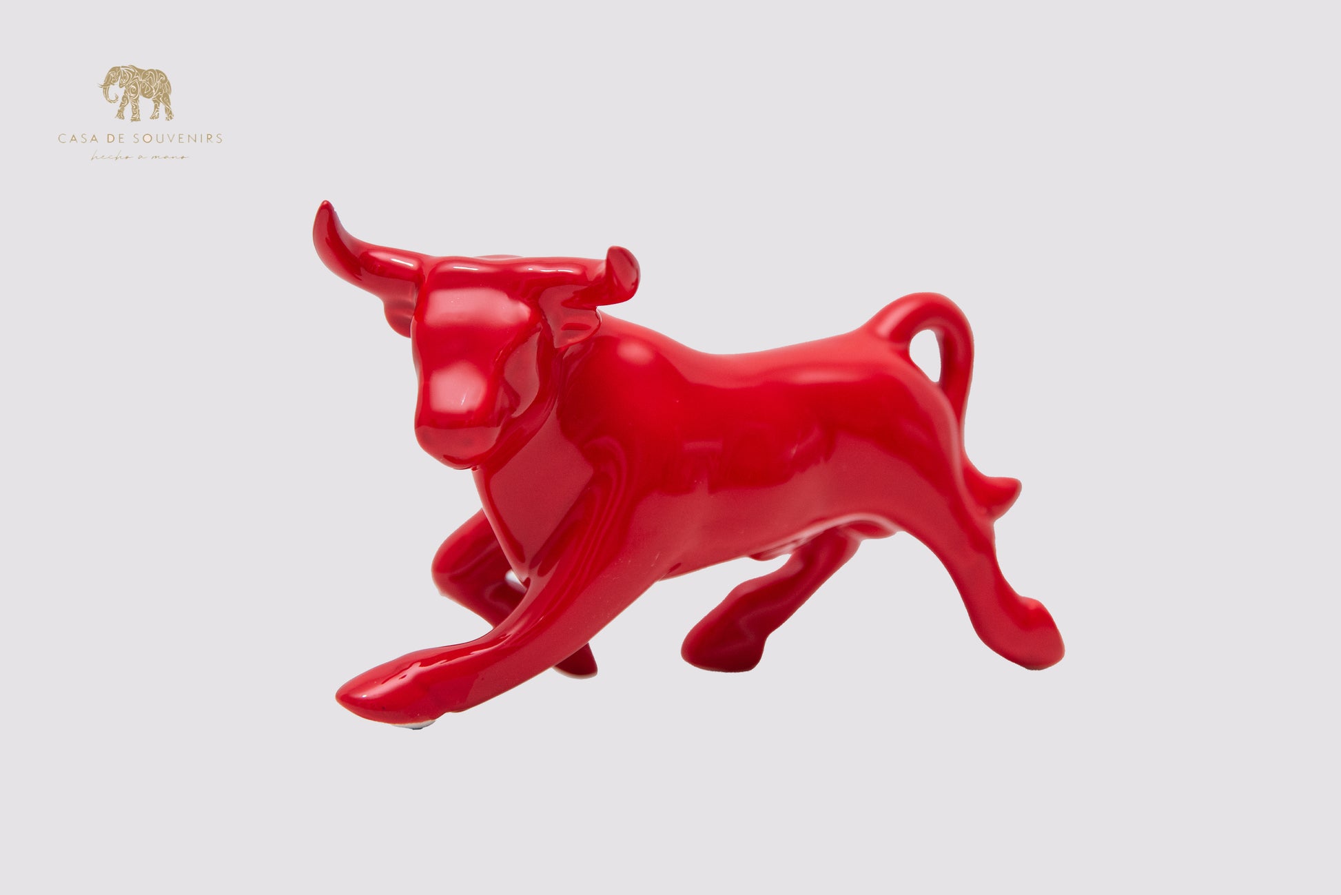 This is a sleek and elegant Red bull figurine made of high-quality porcelain