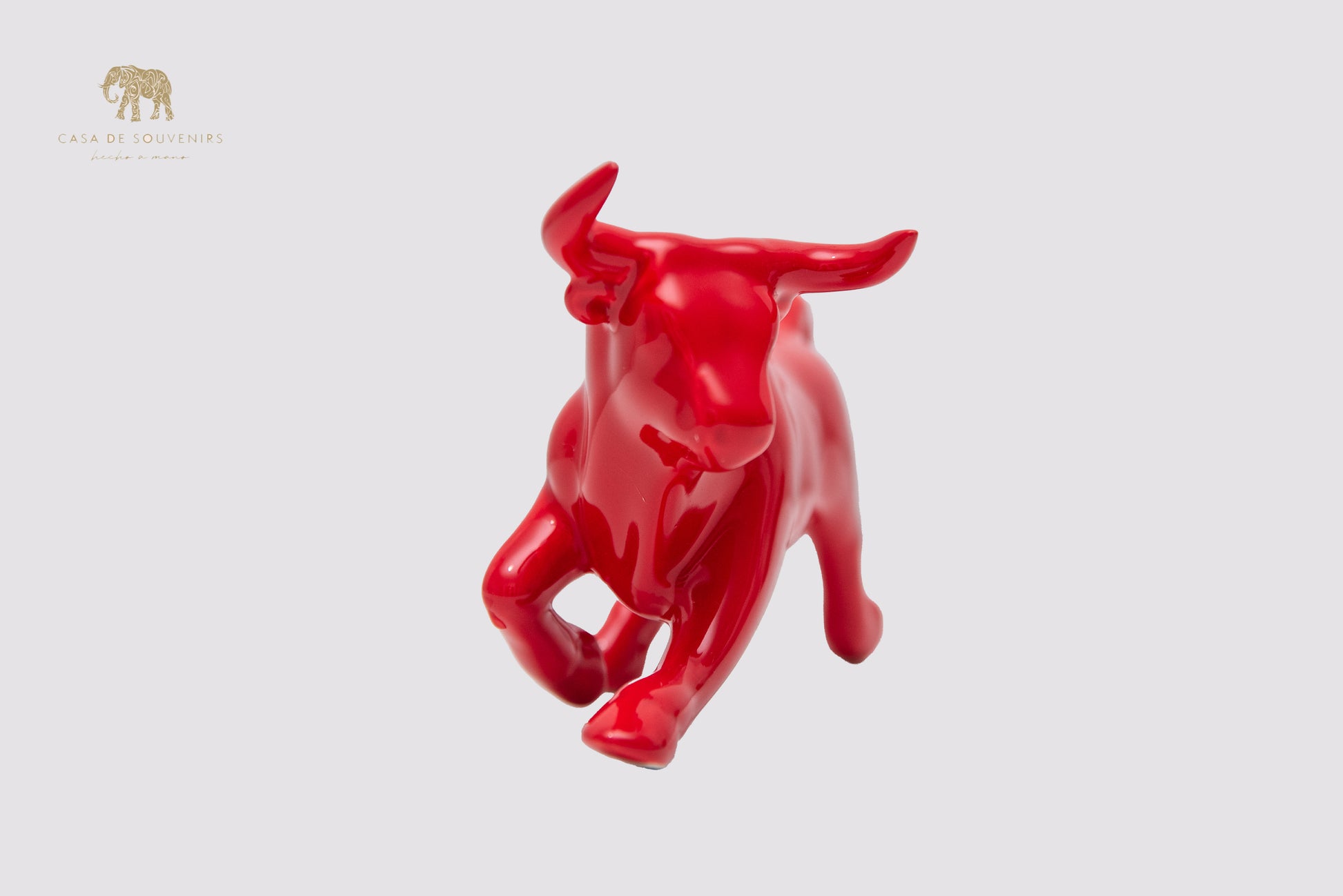 This is a sleek and elegant Red bull figurine made of high-quality porcelain