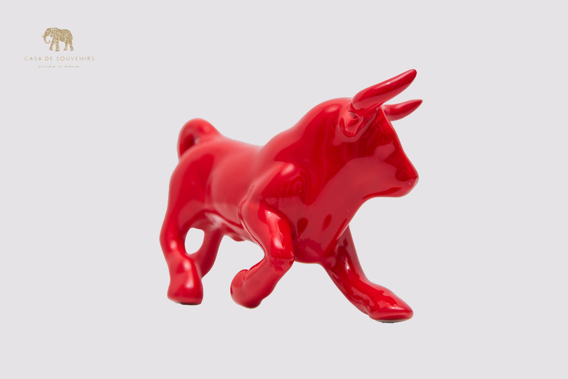 This is a sleek and elegant Red bull figurine made of high-quality porcelain