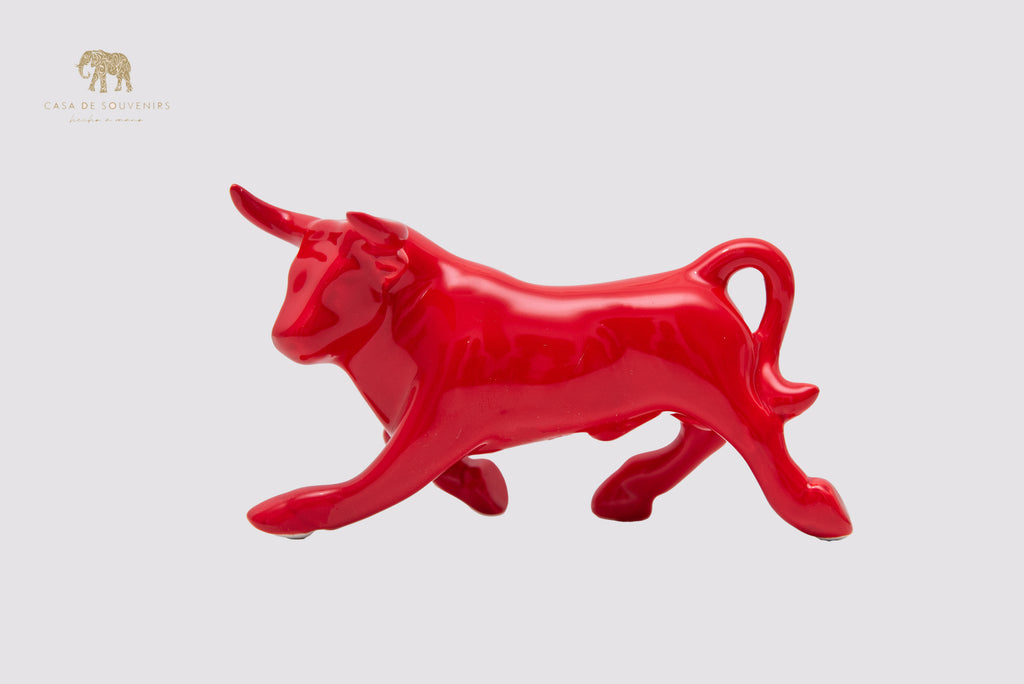 This is a sleek and elegant Red bull figurine made of high-quality porcelain
