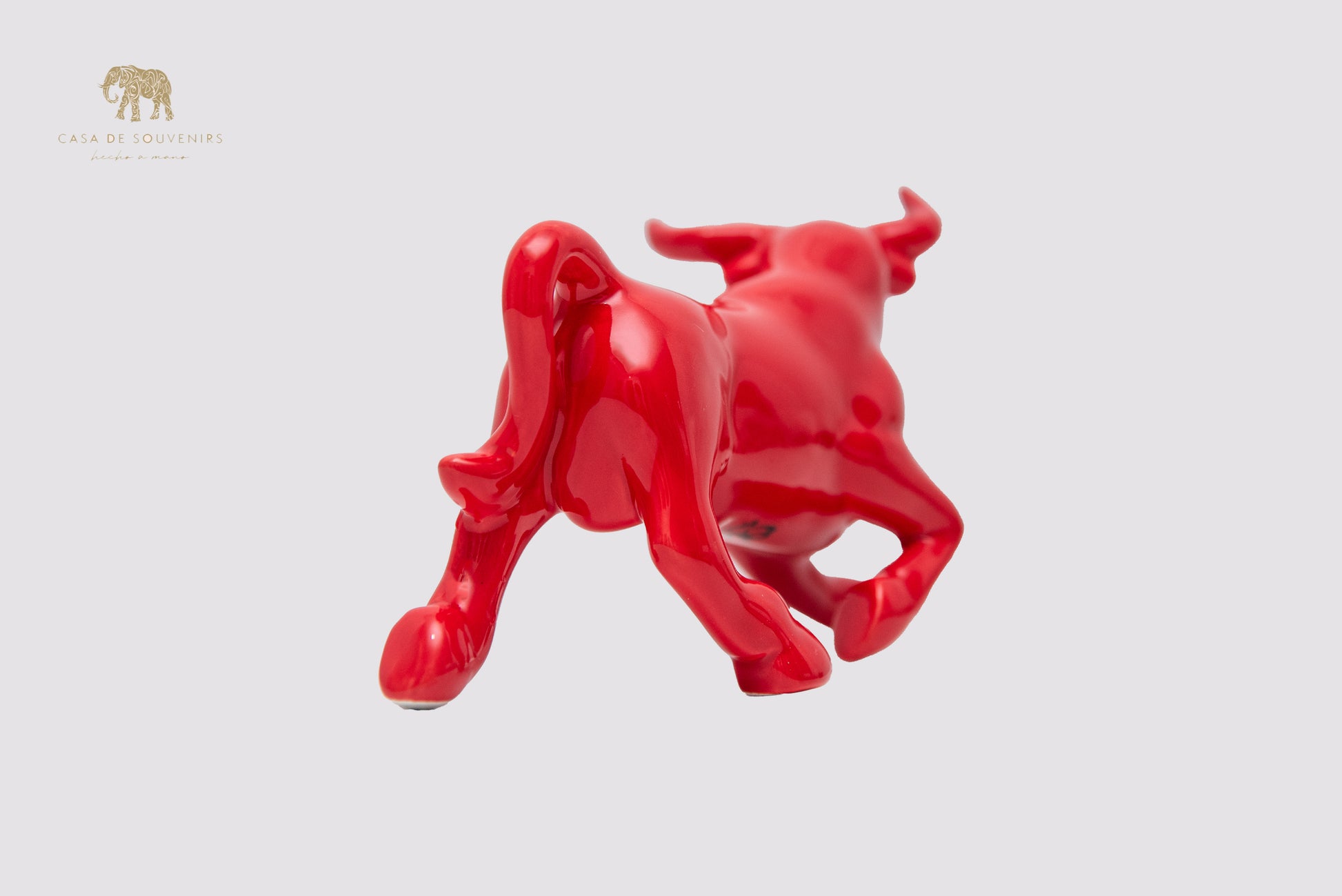 This is a sleek and elegant Red bull figurine made of high-quality porcelain