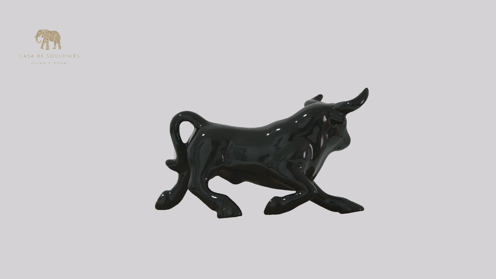This is a sleek and elegant black bull figurine made of high-quality porcelain From Spain