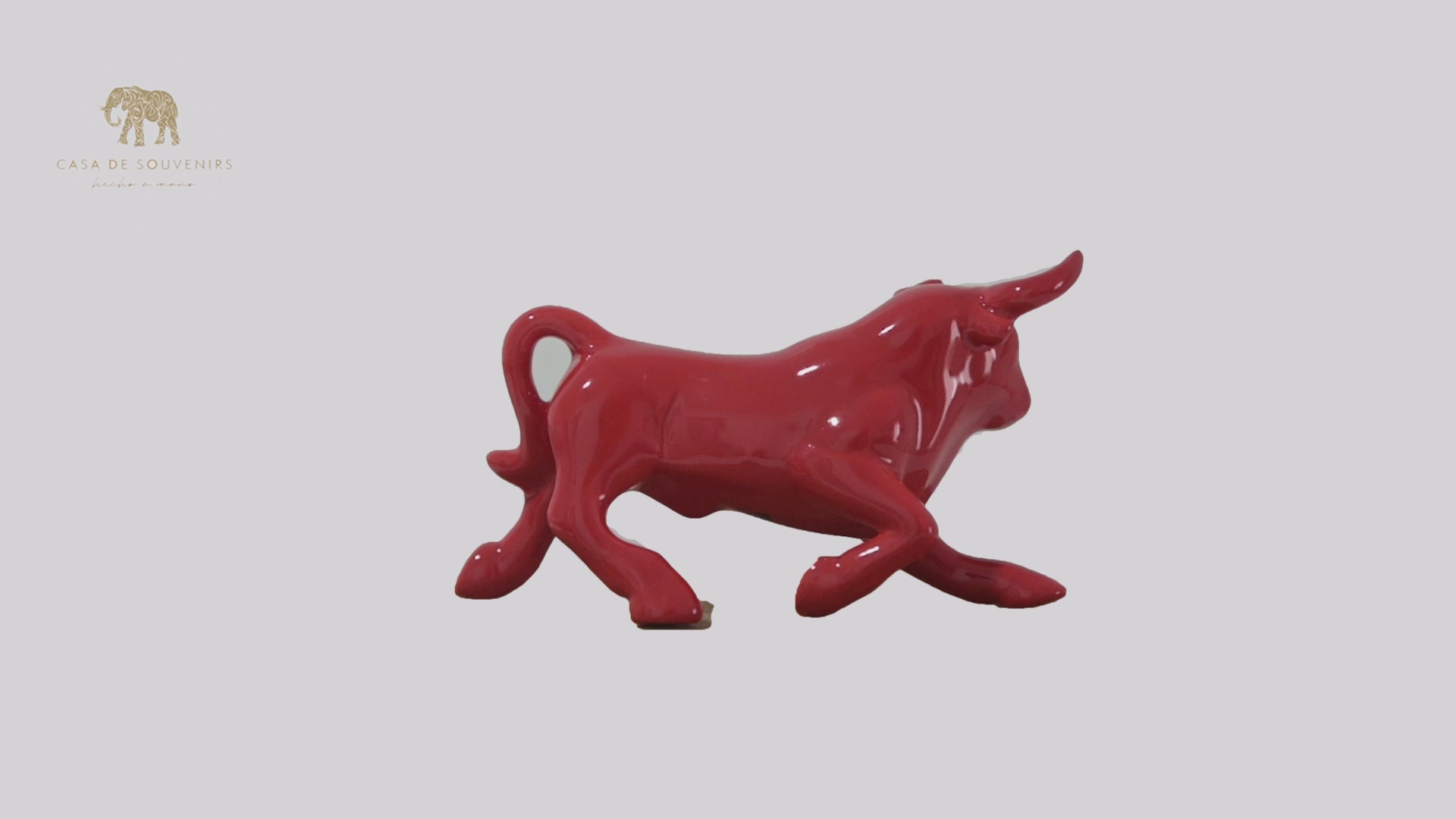 This is a sleek and elegant Red bull figurine made of high-quality porcelain